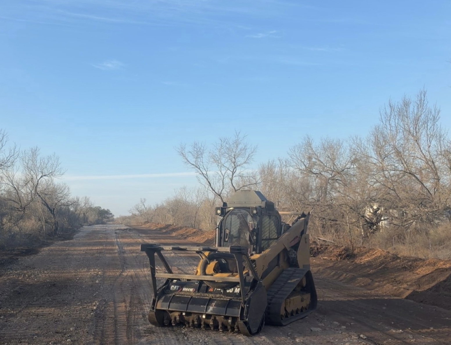 Oro Verde compact track loader working on a prepared ranch road